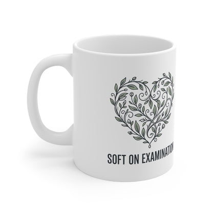 Close-up of the bold print design on the 'Soft on Examination' coffee mug