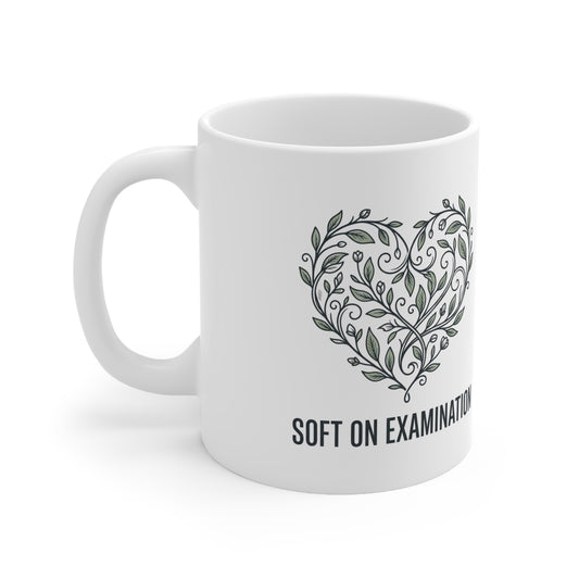 Close-up of the bold print design on the 'Soft on Examination' coffee mug